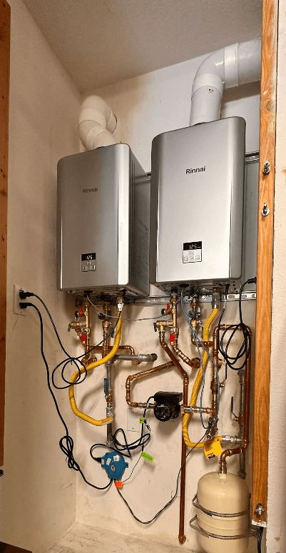 Two Rinnai tankless water heaters installed with a clean copper manifold